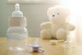 Baby bottle, pacifier and a baby's toy Royalty Free Stock Photo