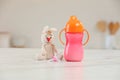 Baby bottle, toy and pacifier on white marble table indoors. Maternity leave concept Royalty Free Stock Photo