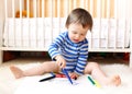 Baby boy age of 18 months paints with pens Royalty Free Stock Photo