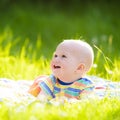 Baby boy with apple on family garden picnic Royalty Free Stock Photo