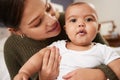 A baby boy arrives, and just like that, everything changes. a young woman carrying her baby at home.