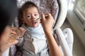 Baby boy being fed water in his high chair at home Royalty Free Stock Photo