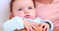 Baby boy in blue babygro with his mother