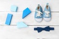 Baby boy blue shoes and blue wooden toys on wooden background. F Royalty Free Stock Photo