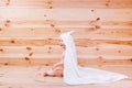 Baby boy with brown eyes is five months old wrapped in a white towel with ears on wooden background . Royalty Free Stock Photo