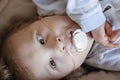 Baby boy with cerebral palsy is getting oxygen via nasal prongs to assure oxygen saturation..Nasal catheter in a child patient in Royalty Free Stock Photo