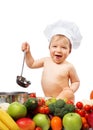 Baby boy in chef hat with cooking pan and vegetables Royalty Free Stock Photo