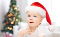 Baby boy in christmas santa hat over blue lights Royalty Free Stock Photo