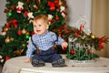 Baby boy with chubby cheeks in blue shirt smiling at Christmas Royalty Free Stock Photo