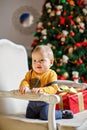 Baby boy with chubby cheeks smiles at Christmas Royalty Free Stock Photo