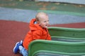 Baby Boy Climbing Up On Slide Royalty Free Stock Photo