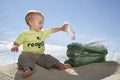 Baby Boy Collecting Bottle In Plastic Bag On Beach Royalty Free Stock Photo