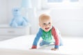 Baby boy crawling on bed Royalty Free Stock Photo