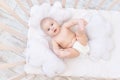 Baby boy in the crib in the nursery, cute funny little baby six months, healthy sleep concept