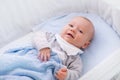 Baby boy in a crib under knitted blanket Royalty Free Stock Photo