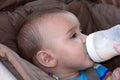 Baby boy drinking bottle in stroller Royalty Free Stock Photo