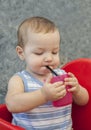 Baby boy drinking by himself with straw Royalty Free Stock Photo