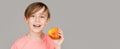 Baby boy eating apple and smiling. Boy smiles and has healthy white teeth. Little boy eating apple. Boy apples showing Royalty Free Stock Photo