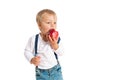 Baby boy eating apple and smiling in the studio isolated on white background Royalty Free Stock Photo