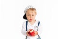 Baby boy eating apple and smiling in the studio isolated on white background Royalty Free Stock Photo