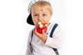 Baby boy eating apple and smiling in the studio isolated on white background Royalty Free Stock Photo