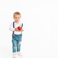 Baby boy eating apple and smiling in the studio isolated on white background Royalty Free Stock Photo