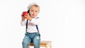 Baby boy eating apple and smiling in the studio isolated on white background Royalty Free Stock Photo