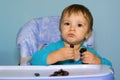 Baby boy eating black grapes Royalty Free Stock Photo