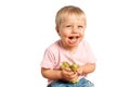 Baby boy eating grapes and smiling in the studio isolated on white background. Concept healthy food Royalty Free Stock Photo