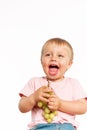 Baby boy eating grapes in the studio isolated on white background. Concept healthy fresh food Royalty Free Stock Photo