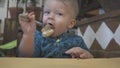 Baby boy eats bread in a restaurant