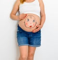 Baby boy   face painted on women  belly Royalty Free Stock Photo