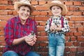 Baby boy farmer, little chicken in his hands and proud woman grandmother outdoor in farmland. Farm animals and happy family in the