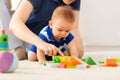 Baby boy with father playing toy blocks at home Royalty Free Stock Photo