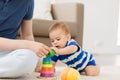 Baby boy with father and pyramid toy at home Royalty Free Stock Photo