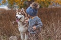 Baby boy in forest with husky dog Royalty Free Stock Photo