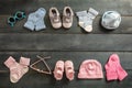 Baby boy and girl shoes and socks on blue wooden background Royalty Free Stock Photo