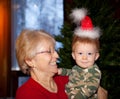 Baby boy and grandma with Santa hat