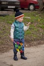 Baby boy in green jaket and blue jeans Royalty Free Stock Photo