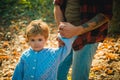 Baby boy has a good time and walk holding father's tattooed strong hand. Happy dad and son spending time together Royalty Free Stock Photo