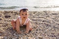 Baby boy in hat on beach pebbles Royalty Free Stock Photo