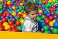 Baby boy having fun playing in a colorful plastic ball pool Royalty Free Stock Photo