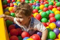 Baby boy having fun playing in a colorful plastic ball pool Royalty Free Stock Photo