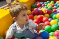 Baby boy having fun playing in a colorful plastic ball pool Royalty Free Stock Photo