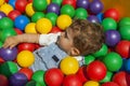 Baby boy having fun playing in a colorful plastic ball pool Royalty Free Stock Photo