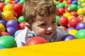 Baby boy having fun playing in a colorful plastic ball pool Royalty Free Stock Photo