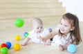 Baby boy and his sister playing with balls. Colorful toys for kids. Kids in play room Royalty Free Stock Photo