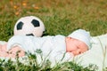 Baby boy infant fun photoshoot soccer football concept big smile having fun playing laughing laying on white furry round through s Royalty Free Stock Photo