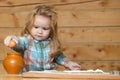 Baby boy in the kitchen cooking, playing with egg. Child to break the eggs.