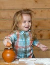 Baby boy in the kitchen cooking, playing with eggs. Child to break the egg. Royalty Free Stock Photo